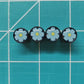 Blue and Yellow Flower Tire Valve Caps - Black Aluminum - Set of Four